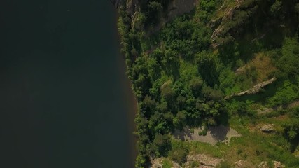 Beautiful top view shot of the riverside with the mountain forest