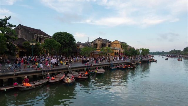 Timelapse or time-lapse of sunset river view with floating lanterns and boats in Hoi An old town. Hoi An is UNESCO world heritage, one of the most popular destinations in Vietnam