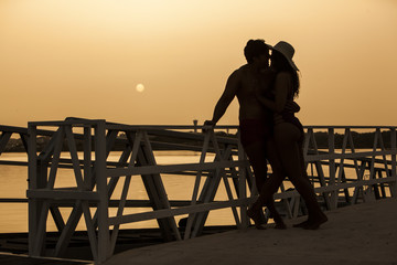 Young and handsome couple enjoying the sunset