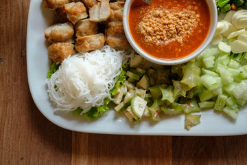 minced pork sausage, fermented rice noodle & vegetable served with chili sauce. vietnamese food called Nem Nuong Xa