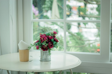 Bouquet of flowers in a decorative pot on the table empty cafe, Filled color filter.