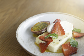 Passion fruit ice cream With fresh strawberries and passion fruit, topped with whipped cream and sprig of fresh peppermint.
