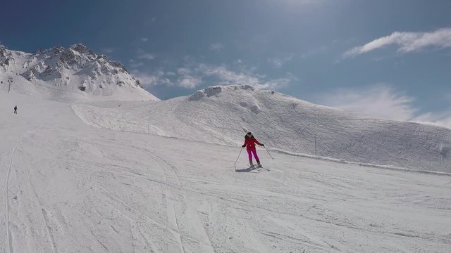 The Beginner Skier Is Skiing Down On The Ski Slope In The Mountains