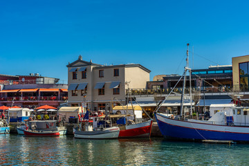 a small harbor during the day with many small boats