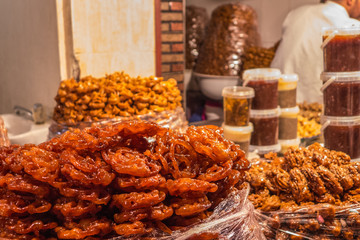 A street food stall in Morocco. Pastry and patisserie are exhibited for sale in bags.