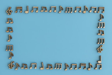 Frame from musical notes on a blue background. Wooden notes on a blue background.