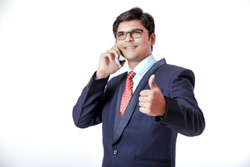 Young Indian businessmen talking on mobile over isolated background