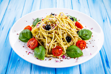 Pasta with vegetables on wooden table