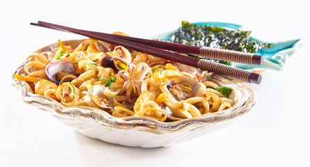 Fried noodles and chopsticks in clamshell