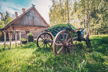 Authentic wooden horse-drawn carriage near the house in the village