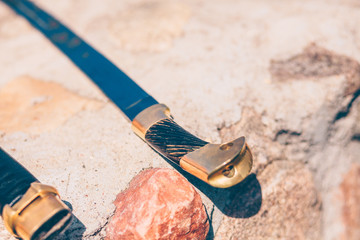 Close-up of a saber handle on a stone wall