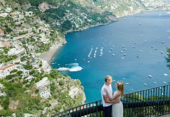 Young romantic couple in love, embracing in the background Positano, Italy