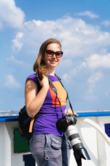 Girl with camera aboard at Mediterranean Sea in Reggio Calabria