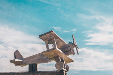 Model of an airplane from the planks against the blue sky