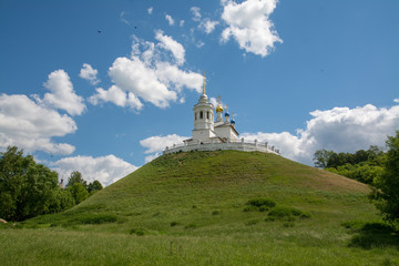 Church standing on a high and green hill