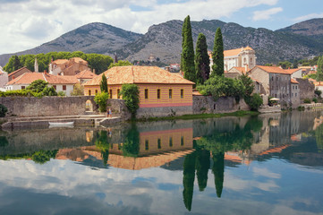 Obraz premium Beautiful ancient town on river bank. Bosnia and Herzegovina, view of Trebisnjica river and Old Town of Trebinje
