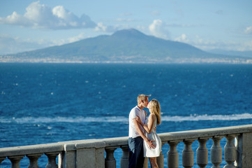 Young romantic couple on a background of a sea landscape and Vesuvius, Naples, Italy