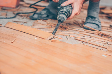 Working with a drill puncher breaks the parquet floor