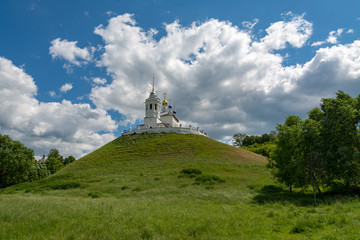 Church standing on a high and green hill