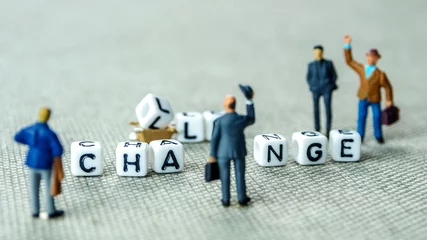 Foto op Plexiglas Removing white cubes with letters l and e of the word challenge creating new word change on grey background with miniature figurines © jan_S