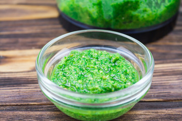sauce pesto, on a wooden background, close-up