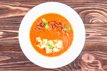 pumpkin cream soup, on a wooden background