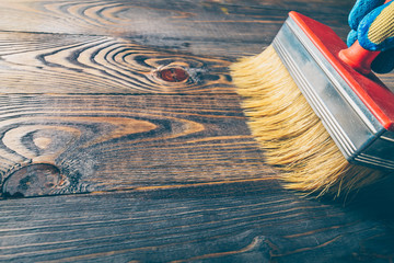 Hand brush covers with oil old wooden floor - repair and restoration of the floor