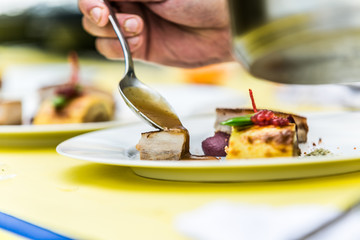 Close up hands of chef preparing food in the kitchen of a restaurant, cooking concept