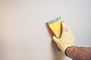 Finishing works - first person view - the master grinds the wall