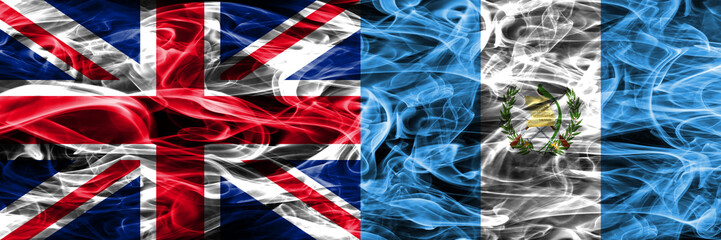 United Kingdom vs Guatemala smoke flags placed side by side. Thick colored silky smoke flags of Great Britain and Guatemala