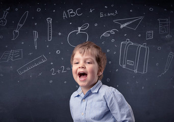 Smart little kid in front of a drawn up blackboard ruminate