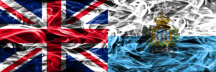 United Kingdom vs San Marino smoke flags placed side by side. Thick colored silky smoke flags of Great Britain and San Marino