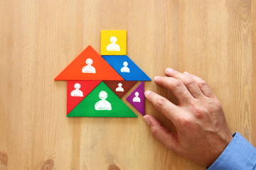 image of tangram puzzle blocks with people icons over wooden table ,human resources and management...