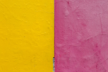 A bright yellow and pink painted wall