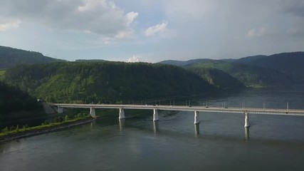 Beautiful drone footage of the bridge with mountains on the background