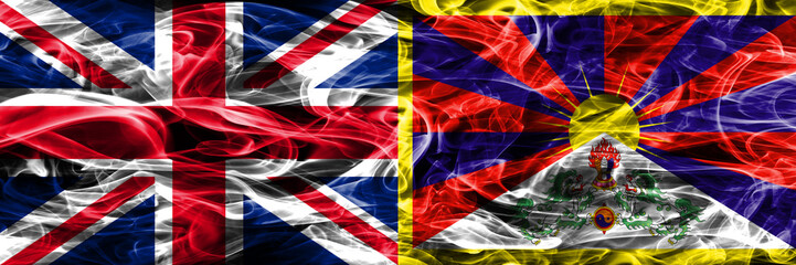 United Kingdom vs Tibet smoke flags placed side by side. Thick colored silky smoke flags of Great Britain and Tibet