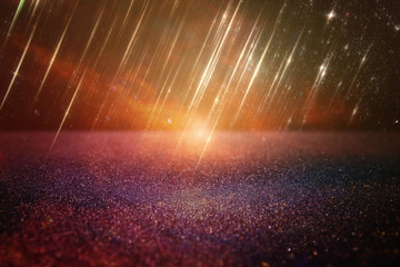 glitter vintage lights background. black, blue and gold. de-focused.