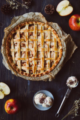 Homemade delicious apple pie with ice cream on the wooden table.