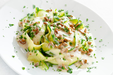 vegetable fettucine under white sauce with chanterellas sprinkled with parsley