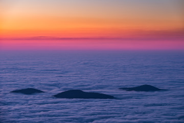 Fototapeta na wymiar Three peaks rising out of inversion clouds, Blue Ridge Mountains