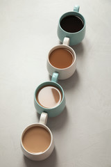 Obraz na płótnie Canvas Cups of fresh aromatic coffee on gray background. Food photography