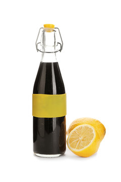 Bottle with natural charcoal lemonade and lemons on white background