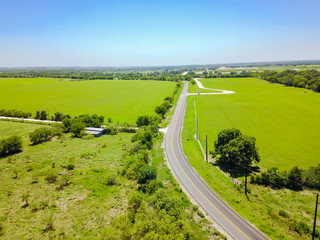 Aerial view green farmland and rolling hill landscape with scenic drive in Hill Country, West...