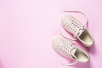 Woman fashion pink shoes on pink background.