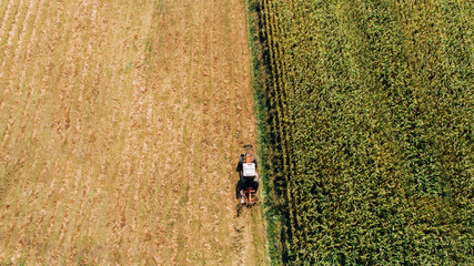 Aerial view of farmer using modern machinery for harvesting