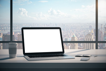 Modern desktop with empty white laptop