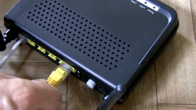 Top view of hand setting up internet router and modem in one