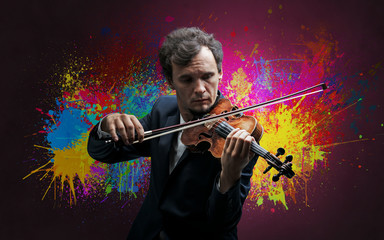 Young classical violinist musician with colorful splotch wallpaper
