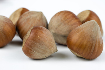 Hazelnuts in shell on a kitchen table. Hazel fruit as an addition to kitchen dishes.