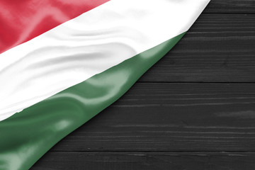 Flag of Hungary and place for text on a dark wooden background